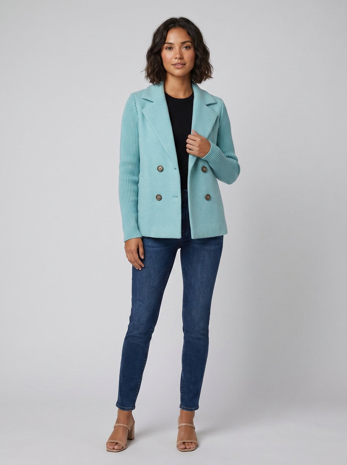 Woman wearing light blue knit-sleeve blazer with jeans