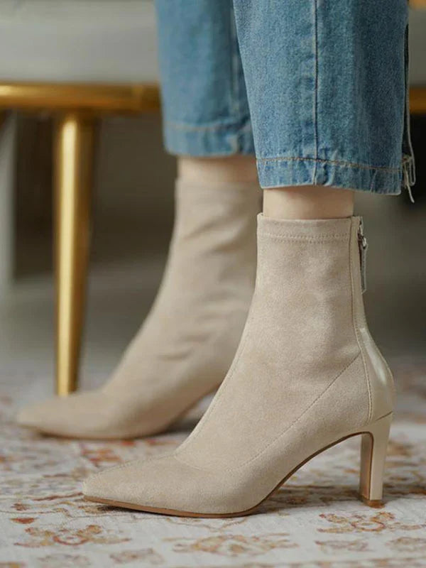Woman wearing Juno apricot sock boots, sitting, close crop