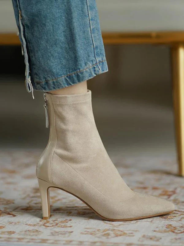 Woman wearing Juno apricot sock boots, standing, close crop