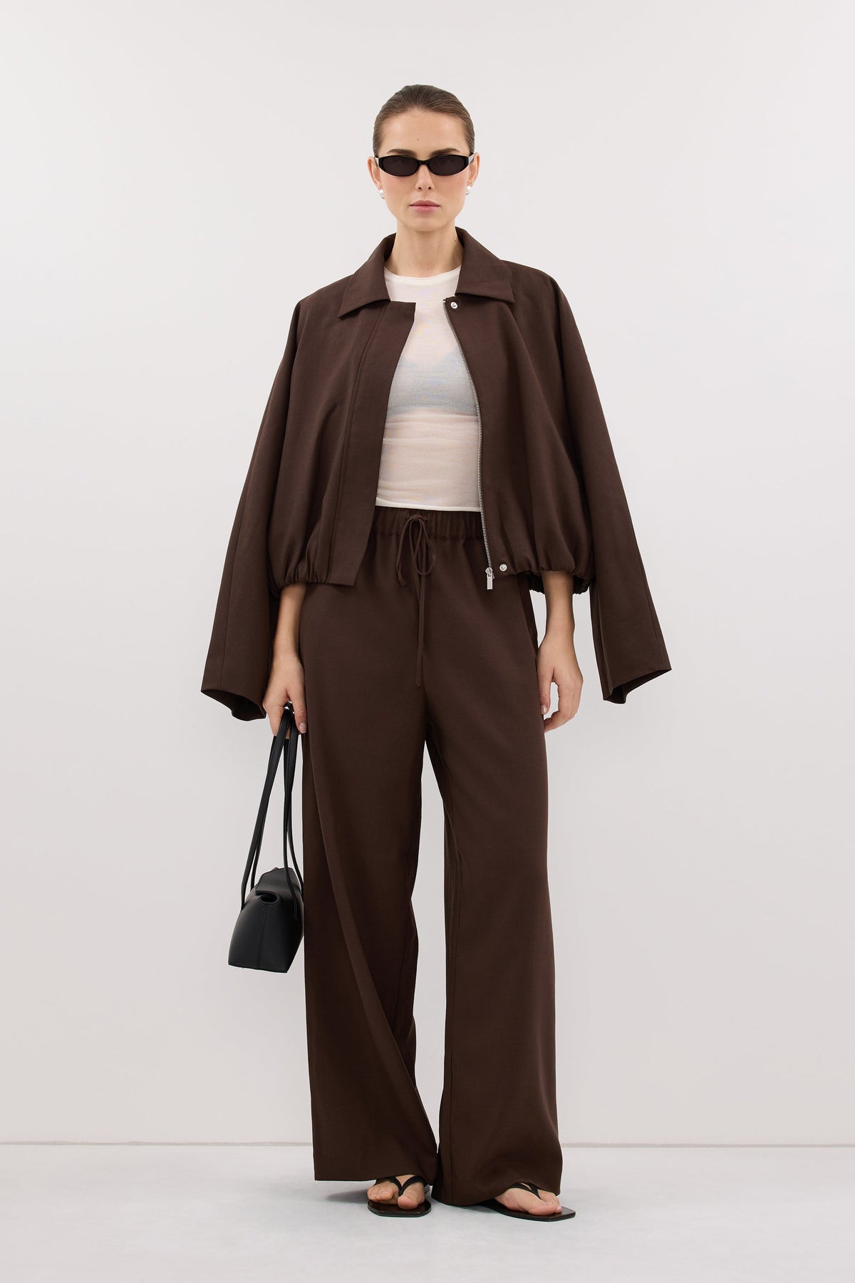 Kora brown wide-leg pants styled with a jacket, front view