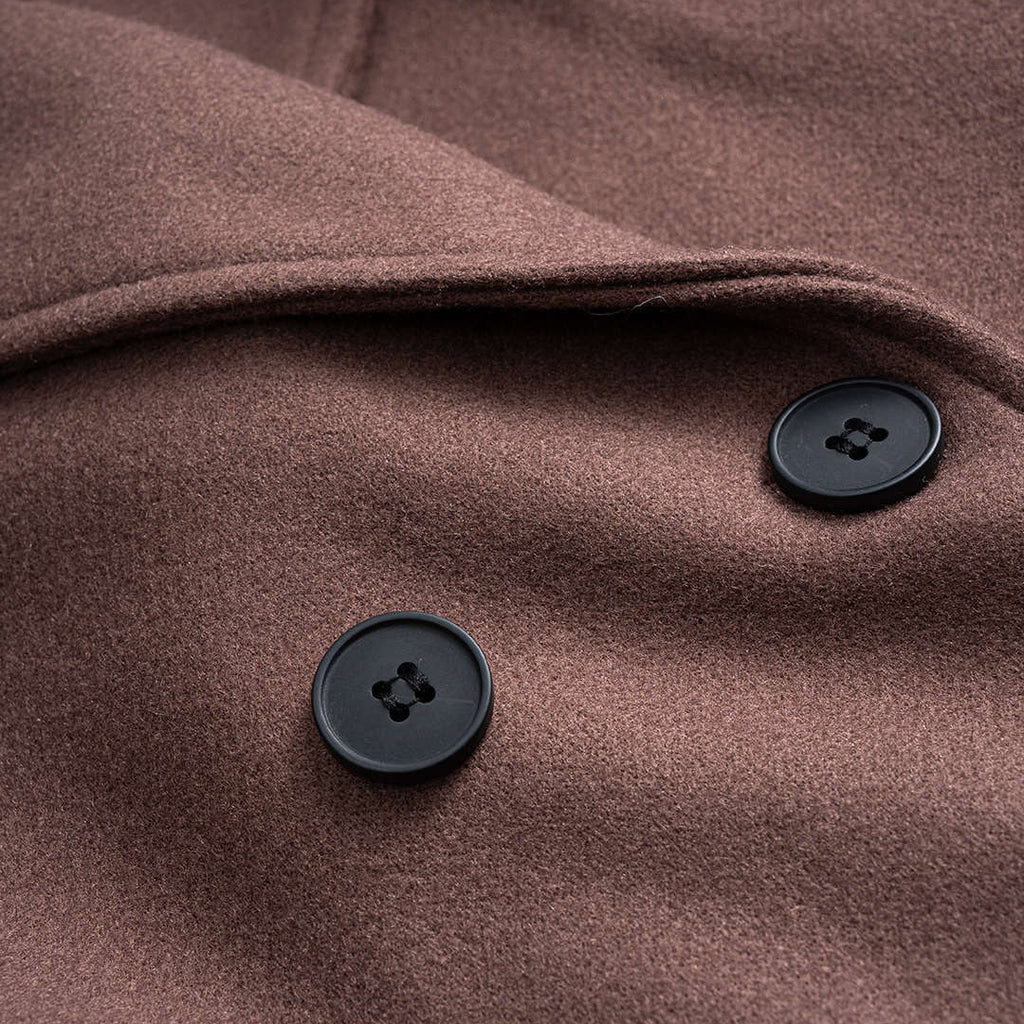 Noor double-breasted coat in brown, close-up of the button detail