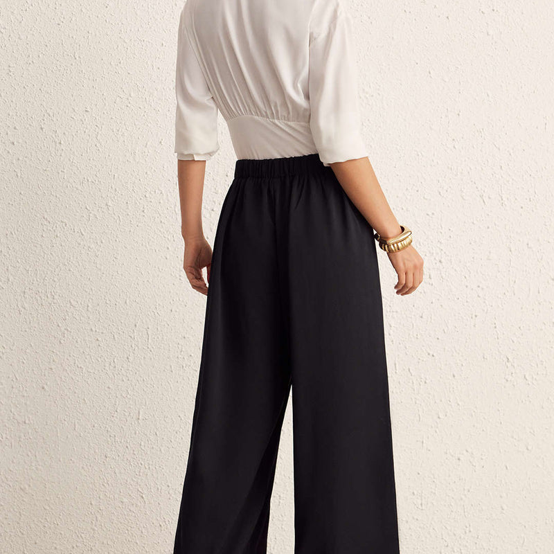 Woman wearing Nova black wide-leg pants, back view