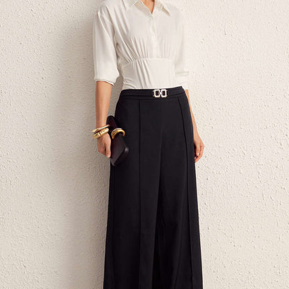 Woman wearing Nova black wide-leg pants with a white blouse, front view