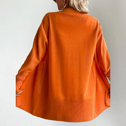 Woman wearing Talia cardigan in orange, back view