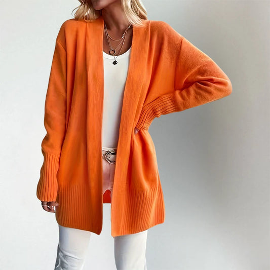 Woman wearing Talia cardigan in orange, front view
