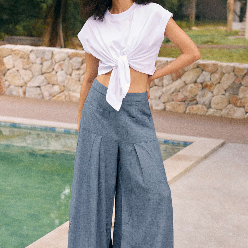 Woman wearing Vera powder blue wide leg trousers with a tied top, front view