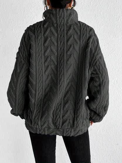 Women's cable-knit zip-neck sweater in dark grey, back view