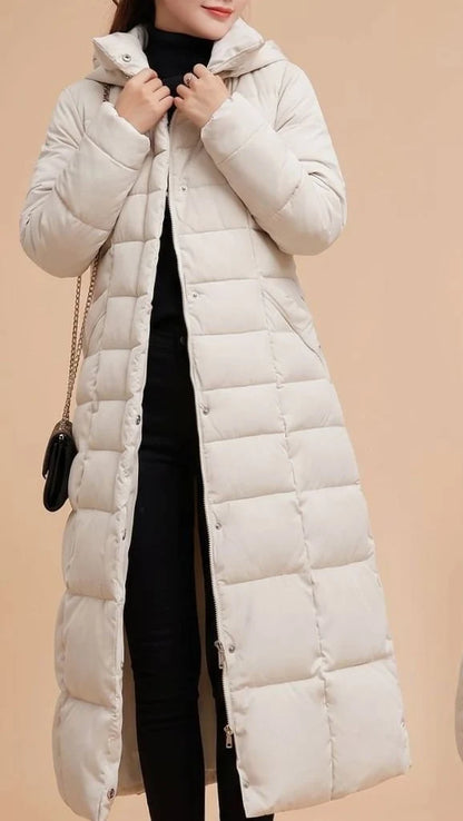 Emilia long quilted winter coat with faux fur trimmed hood in beige, front view on model