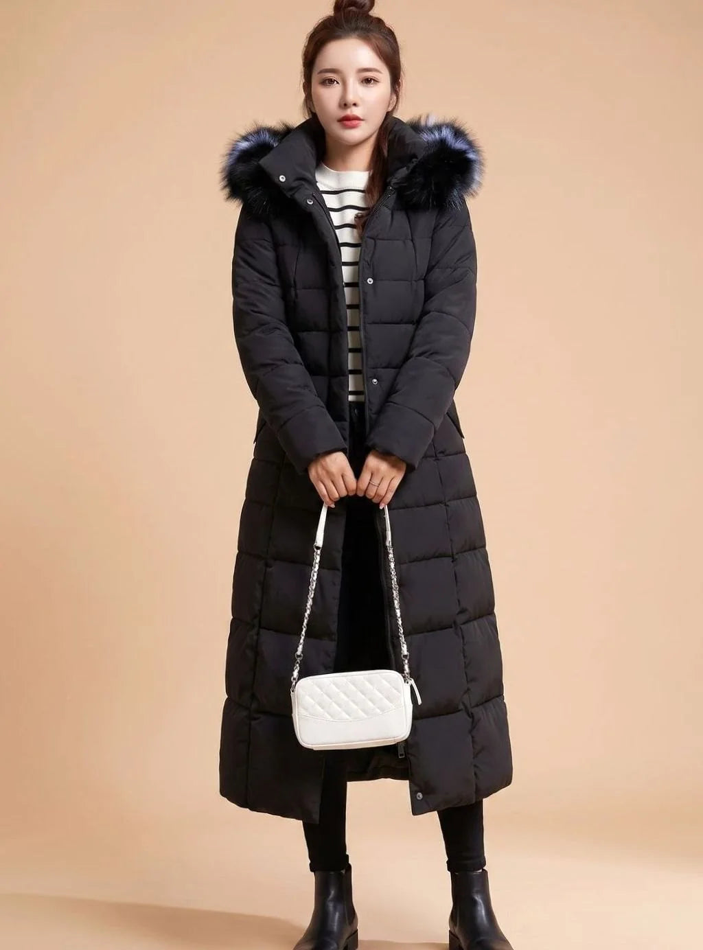 Emilia long quilted winter coat with faux fur trimmed hood in black, front view on model