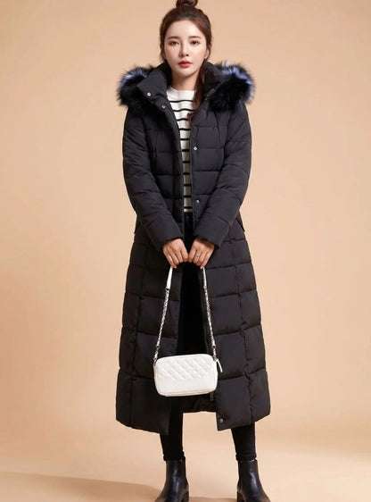 Emilia long quilted winter coat with faux fur trimmed hood in black, front view on model
