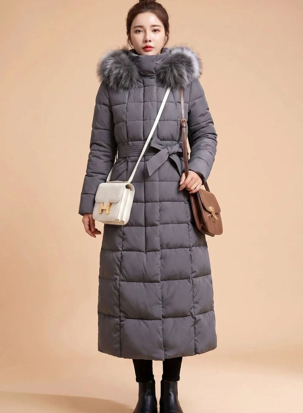 Emilia long quilted winter coat with faux fur trimmed hood in gray, front view on model