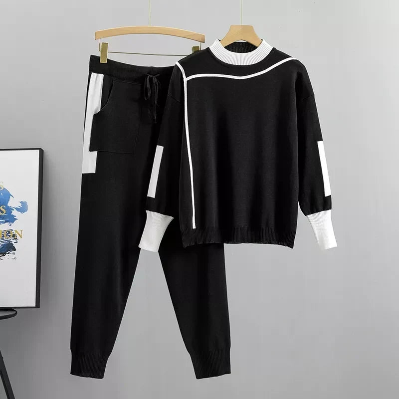 Black colorblock knit sweater and joggers on hanger