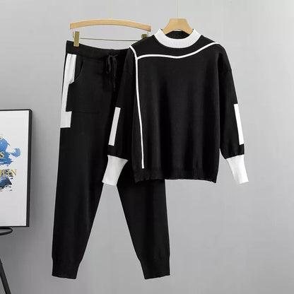Black colorblock knit sweater and joggers on hanger