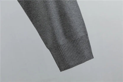 Grey knit sweater ribbed cuff detail