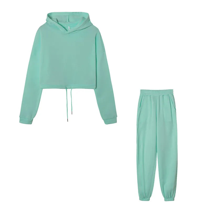 Women's green cropped hoodie and joggers set, flat lay