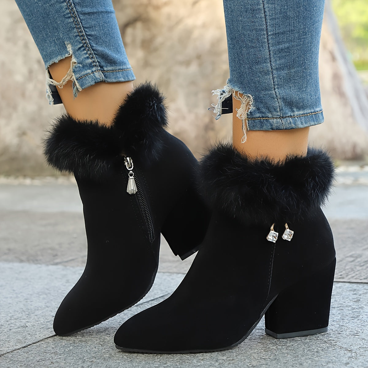 Women's black faux fur trim ankle boots with block heel and pointed toe, worn view