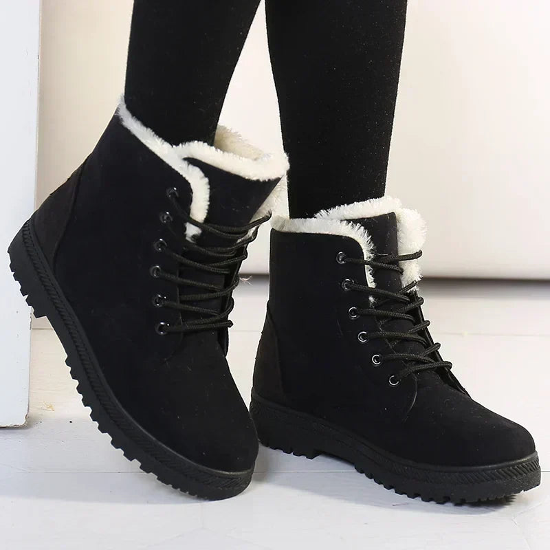 Black fleece-lined lace-up ankle boots with textured tread, worn view