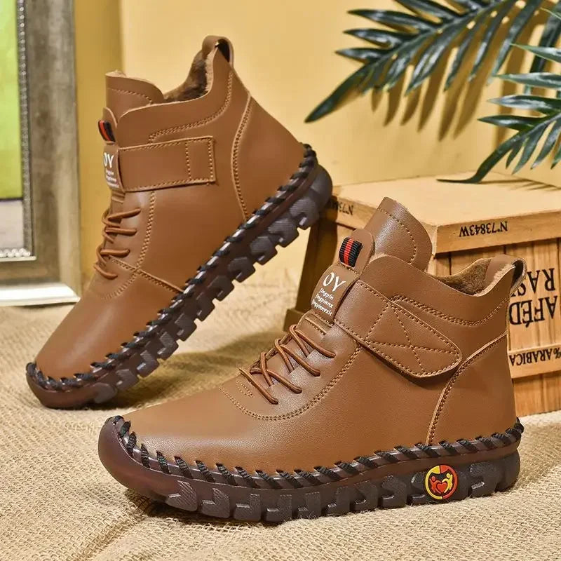 Brown lace-up mid-top ankle boots with deep tread sole, side view