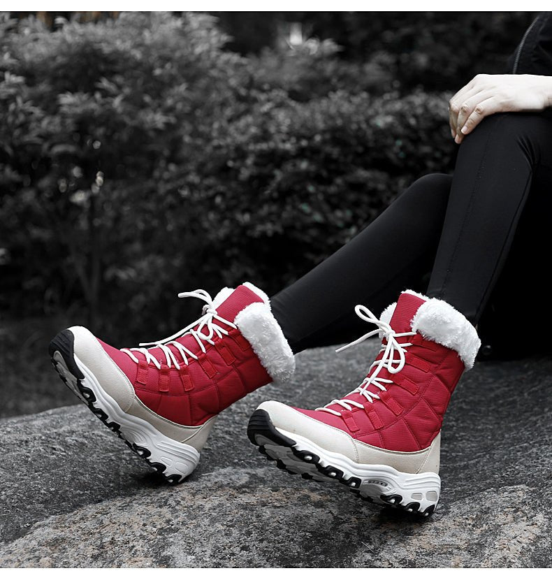 Red lace-up snow boots, worn view