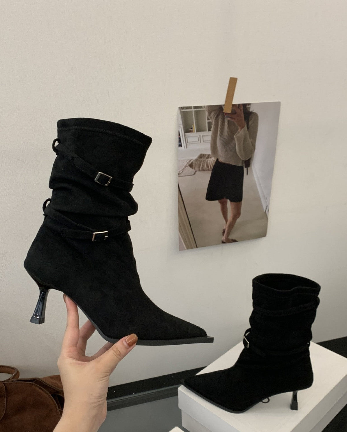 Women's black slouch ankle boots with buckle straps and pointed toe
