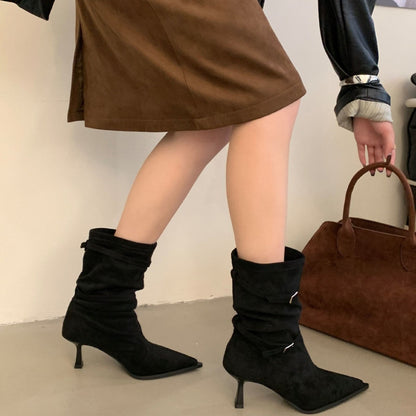 Black slouch ankle boots with double buckle straps, worn view