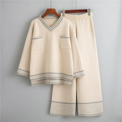 Women's beige V-neck knit lounge set with wide-leg pants and contrast stitching, on hanger