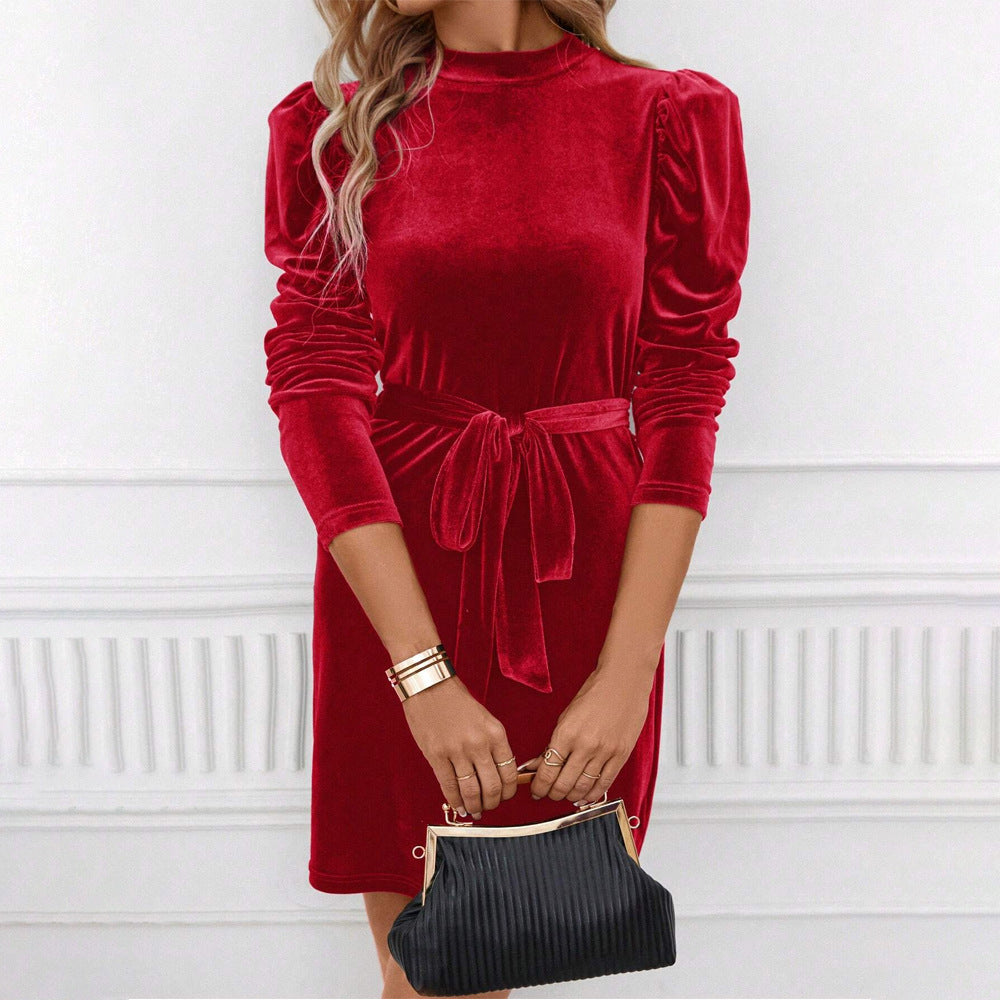 Red velvet mini dress with long sleeves, styled with clutch