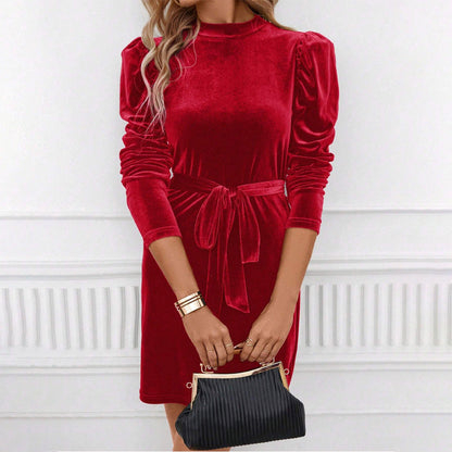 Red velvet mini dress with long sleeves, styled with clutch